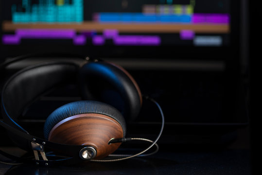 Hi-Fi headphones and computer in a home-studio audio recording and producing
