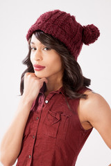 Pensive woman in a red knit cap