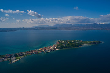 Sirmione town, Lake Garda, Italy. Aerial view of Sirmione high altitude. Side view of the island.