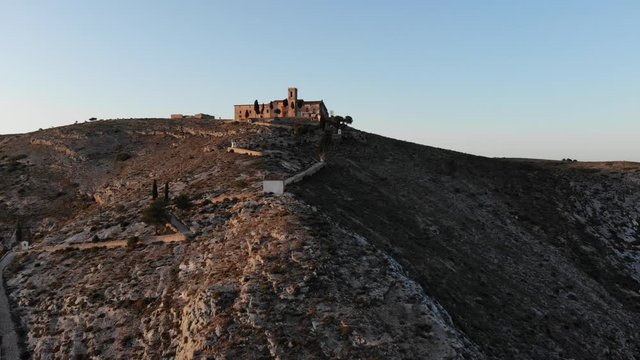 Aerial drone clp over a chapel in the top of a mountain in Bocairent, Spain during sunset