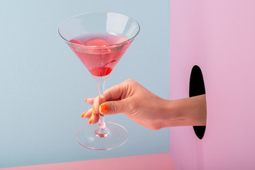 Woman's hand holding a glass of red prosecco