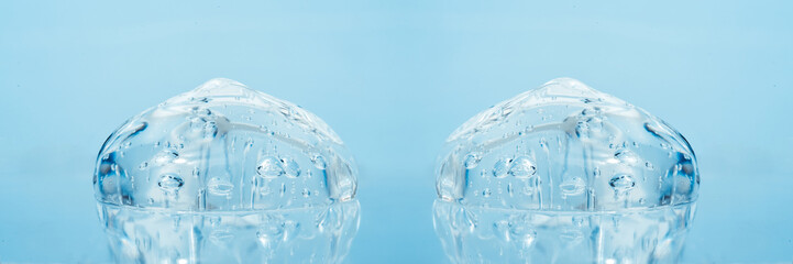 Texture of hyaluronic acid, serum gel, silicone implants, Transparent smear of gel on blue...