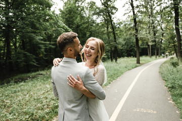 Fototapeta premium Crazy with happiness couples on wedding day, wedding day wedding beautiful bride and elegant groom walk after wedding luxury