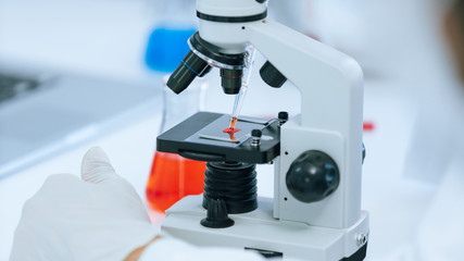 close up. microscope is on the table in the lab.