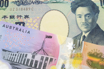 A macro image of a Japanese thousand yen note paired up with a colorful five dollar bill from Australia.  Shot close up in macro.