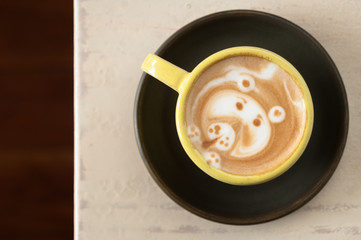 cup of coffee with a latte desing on a white table