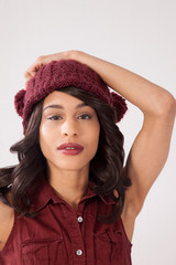 Pensive woman in a red knit cap