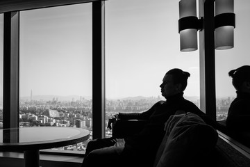 silhouette of a person with a suitcase at the window