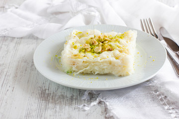 Traditional turkish meal - Gullac. Milk dessert sprinkled with ground nuts and pistachios