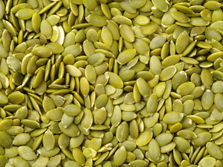 Macro background texture of green pumpkin seeds