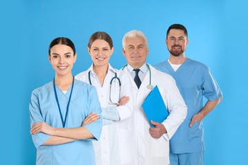 Fototapeta premium Group of doctors against blue background. Medical service