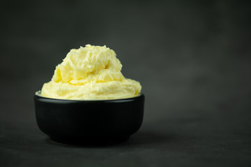 Soft butter in black bowl