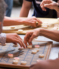 Men playing the checkers game on the streets of Phnom Penh in Cambodia