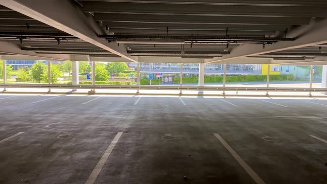 panning over empty parking garage with view on bright surroundings