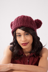Pleased woman in a red knit cap