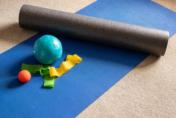 Foam roller and Pilates equipment on floor mat