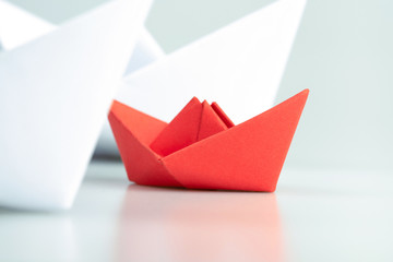 Small business, Business competition concept with red paper ship on white background