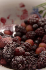 Frozen berries on a plate. Summer fresh berries. Selective focus.
