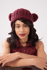 Pleased woman in a red knit cap