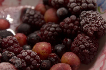 Frozen berries on a plate. Summer fresh berries. Selective focus.