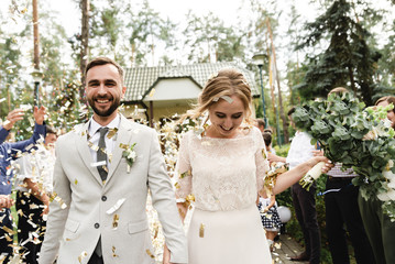 wedding confetti,newlyweds are greeted with festive confetti,joyful bride and groom go on a wedding...