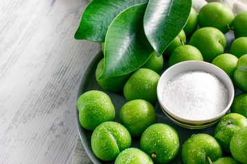 Unripe sour green plums with salt. Traditional turkish snack - Tuzlu erik