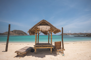 tropical beach with umbrella and chair in Lombok