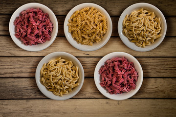 Fresh italian pasta in a wooden background top view