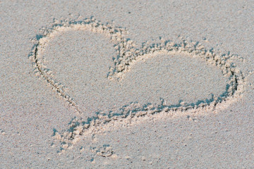 Heart drawn on the sand. Love, summer and holidays concept
