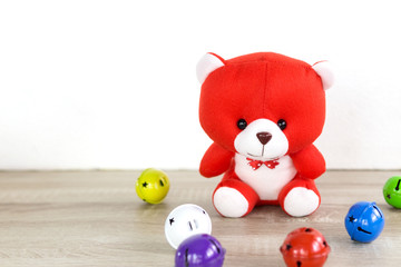 teddy bear with red bell shaped balloon