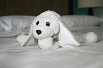 this is a plush dog sitting funny