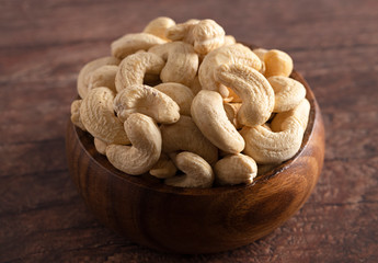 Bowl of Raw Natural Cashews  on a Wooden Table