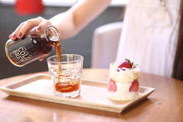 strawberry cake next to cold drink
