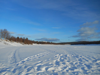 Fototapeta na wymiar Snowy view from frozen lake in FInland