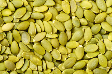 Macro background texture of green pumpkin seeds