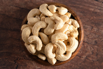 Bowl of Raw Natural Cashews  on a Wooden Table
