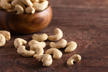 Bowl of Raw Natural Cashews  on a Wooden Table