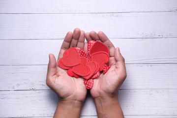 woman holding red heart in hands, donate or charity concept