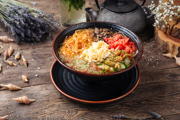 Korean noodle dish kuksi with beef and vegetables