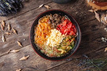 Korean noodle dish kuksi with beef and vegetables