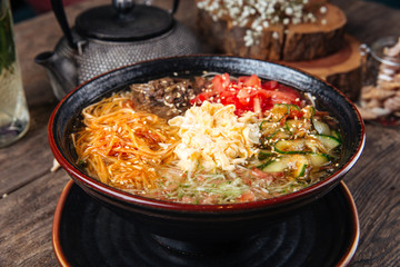 Korean noodle dish kuksi with beef and vegetables