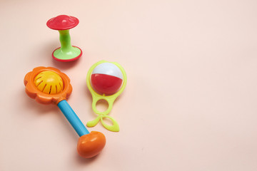 Plastic Retro Rattle. Baby toys on pink background. Flat lay. Copy space.