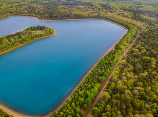 Landscape panorama, blue water in a forest lake with trees