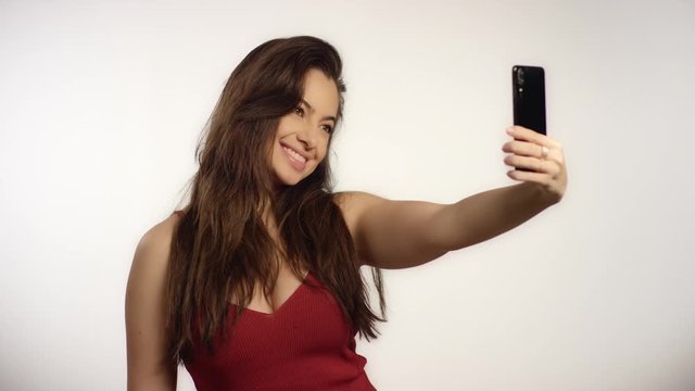 Smiling Woman Takes Selfie