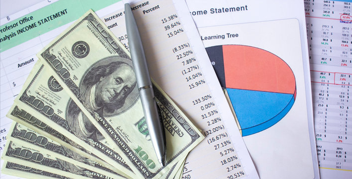 Stack Of Graphic Financial Reports, Market Analysis, Pile Of Ben Franklin 100 Dollar Bills And Blue Pen. Close-up Graphs And Charts. Concept Image Of Invest Planning, Analyze Return On Investment.