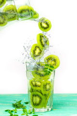 Refreshing cocktail with kiwi. Fruit green lemonade with ice and mint in glasses. Isolated on white background
