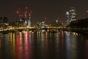 Fototapeta na wymiar Night photo of London with illuminated Thames and building with many lights