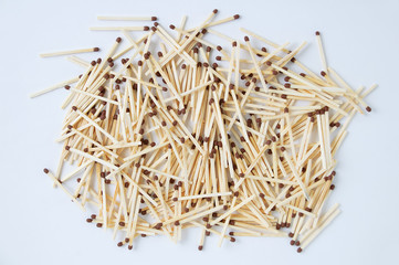 pile of wooden matches in bulk. View from above. White background.