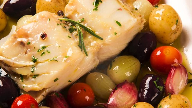 Slide shot codfish on the plate with smoke. Top View.