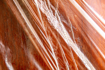 Plastic films on a red wooden board.